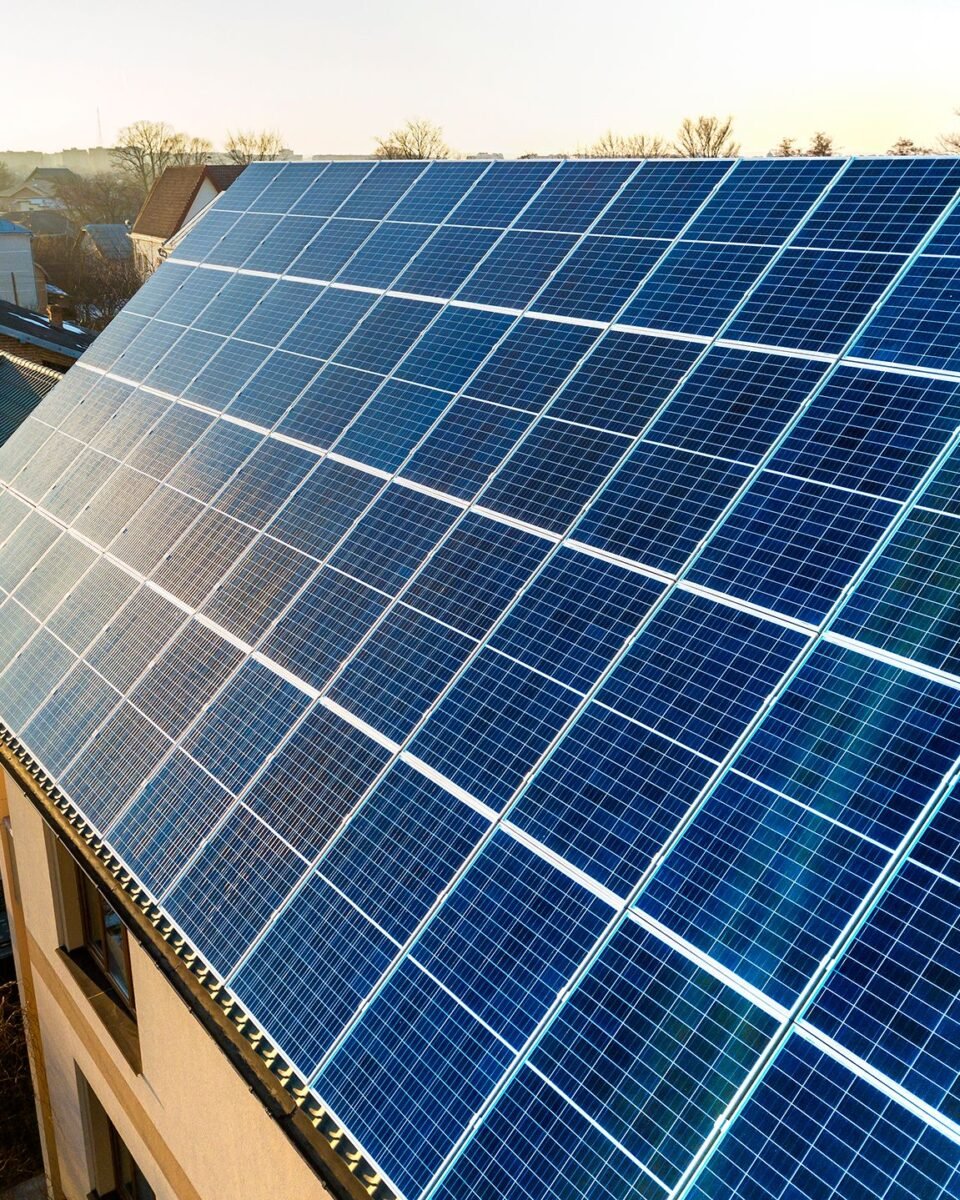 aerial-view-new-modern-two-story-house-cottage-with-blue-shiny-solar-photo-voltaic-panels-system-roof-renewable-ecological-green-energy-production-concept